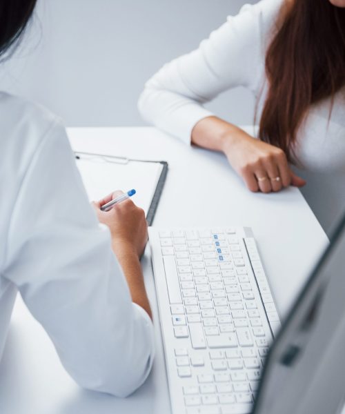 Pregnant woman have consultation with obstetrician indoors.